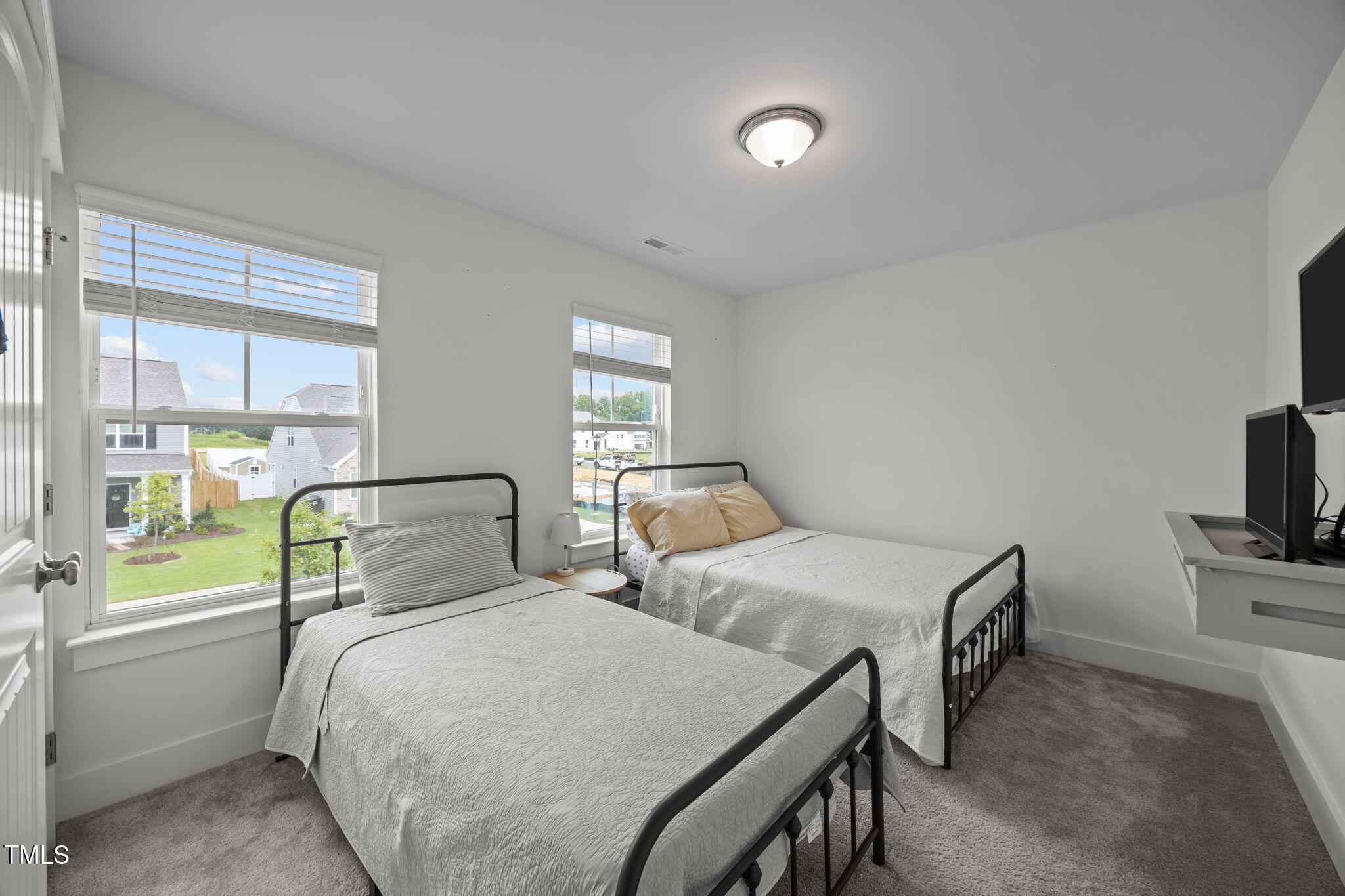 456 Highview Drive Benson, NC 27504 - Photo 22 of 36 a bedroom with two beds and a flat tv screen on the dresser