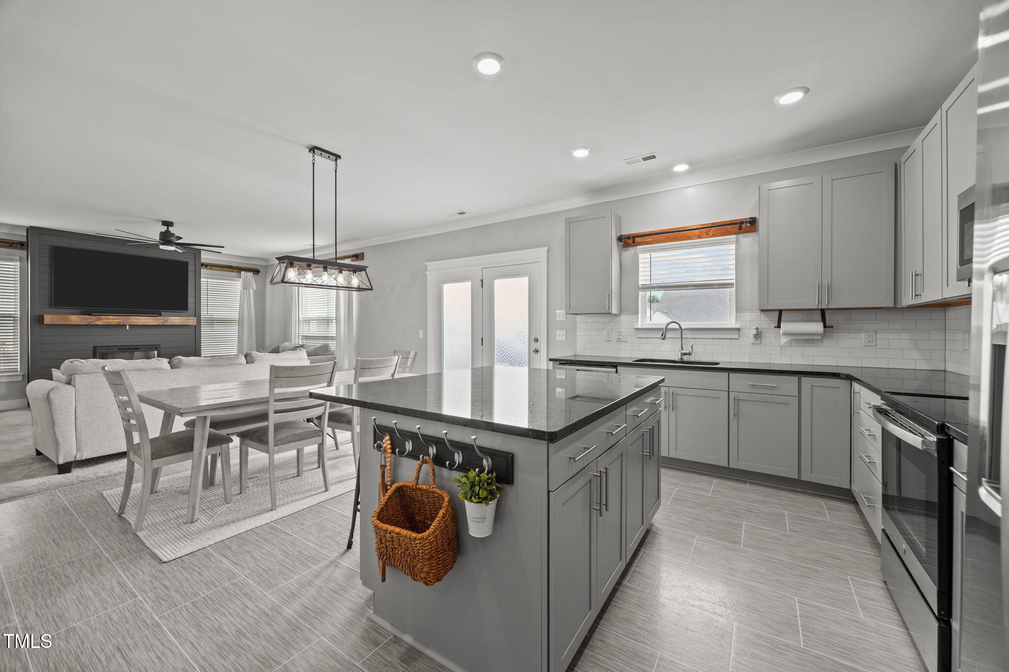 456 Highview Drive Benson, NC 27504 - Photo 3 of 36 a kitchen with stainless steel appliances granite countertop a stove top oven a sink dishwasher a dining table and chairs with wooden floor