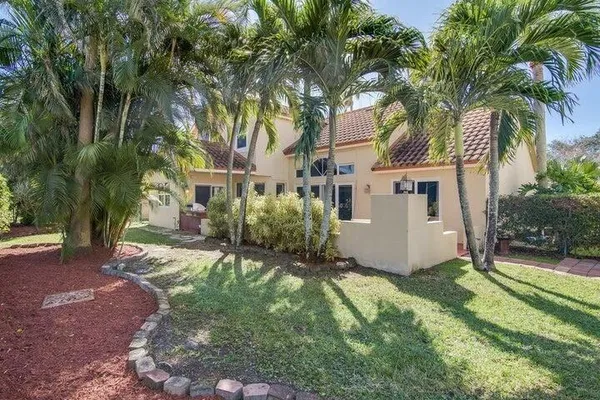 a view of a house with a tree in a yard