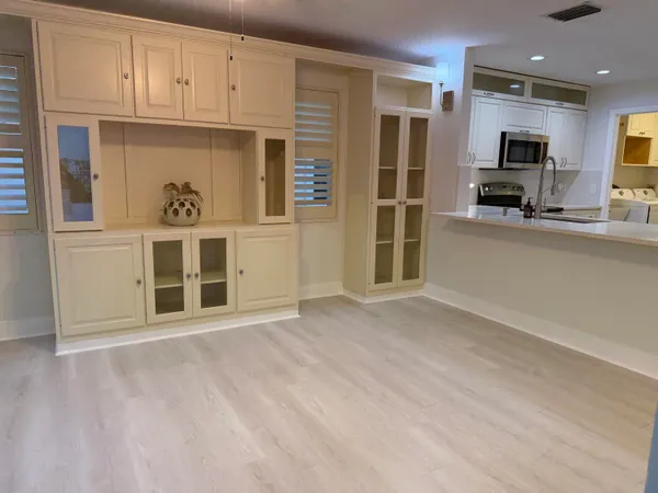 a view of a kitchen with stainless steel appliances cabinets