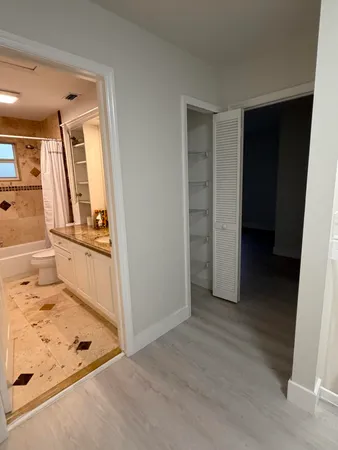 a front view of a house with a garden and trees