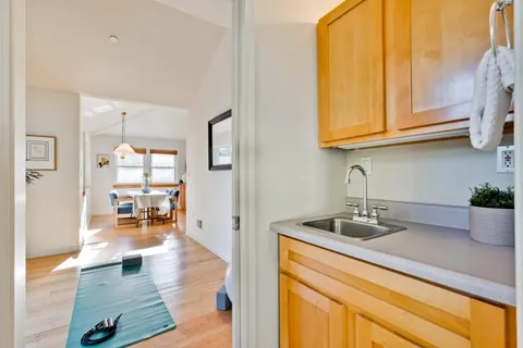 a kitchen with stainless steel appliances granite countertop a sink dishwasher and cabinets with wooden floor