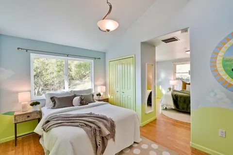 a bedroom with a bed and a large window