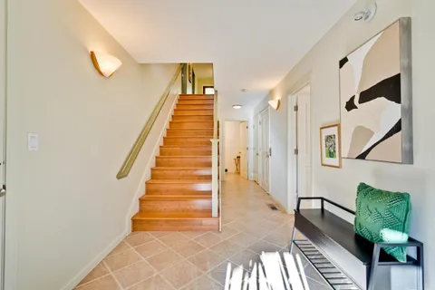 a view of entryway and hall with wooden floor