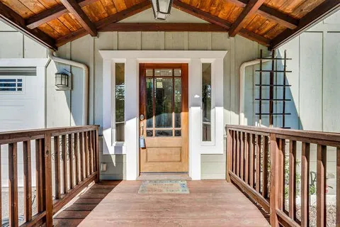 a view of a porch with wooden floor and stairs