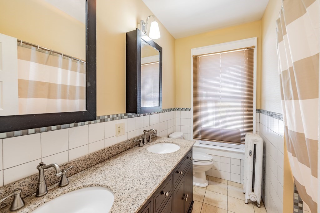 47 Magnolia Terrace Springfield, MA 01108 - Photo 17 of 37 a bathroom with a granite countertop sink and a mirror