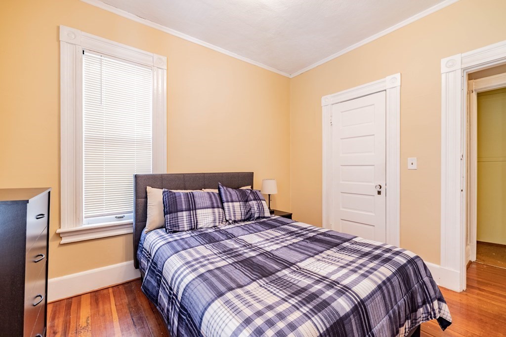 47 Magnolia Terrace Springfield, MA 01108 - Photo 25 of 37 a bedroom with a bed and wooden floor