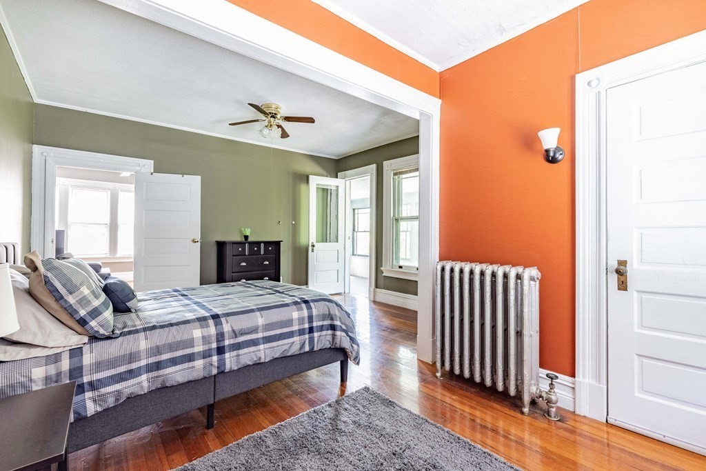 47 Magnolia Terrace Springfield, MA 01108 - Photo 28 of 37 a bedroom with a bed and wooden floor
