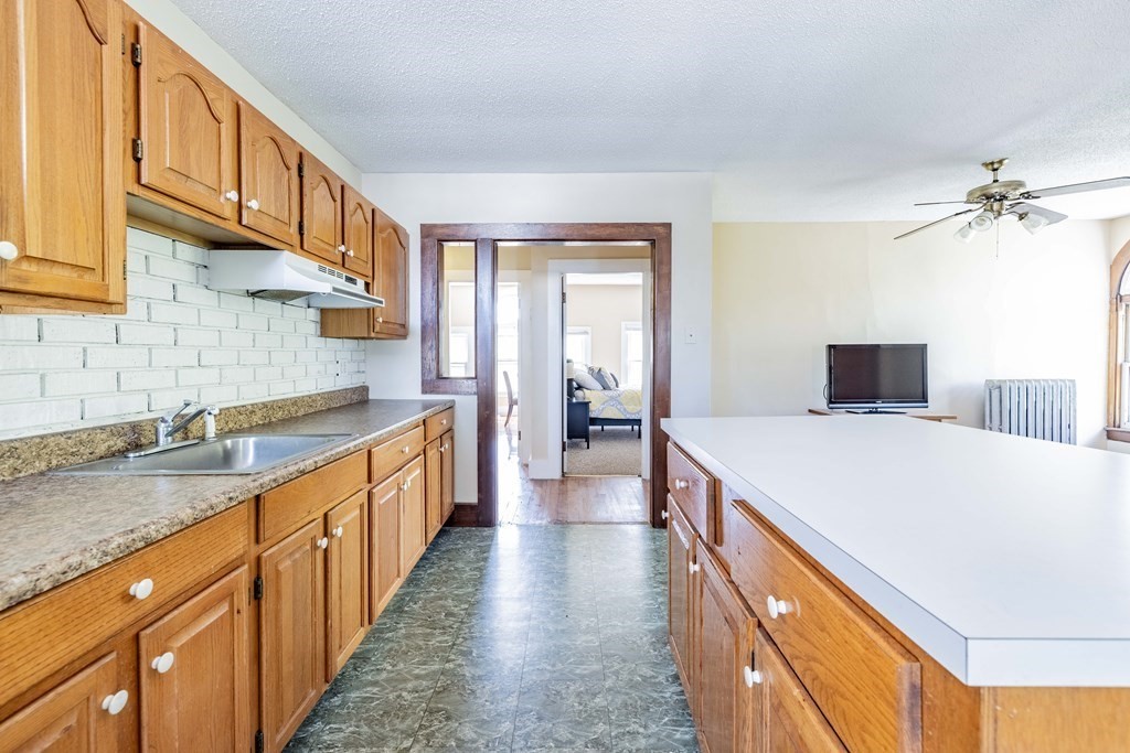 47 Magnolia Terrace Springfield, MA 01108 - Photo 32 of 37 a kitchen with a stove a sink and a refrigerator