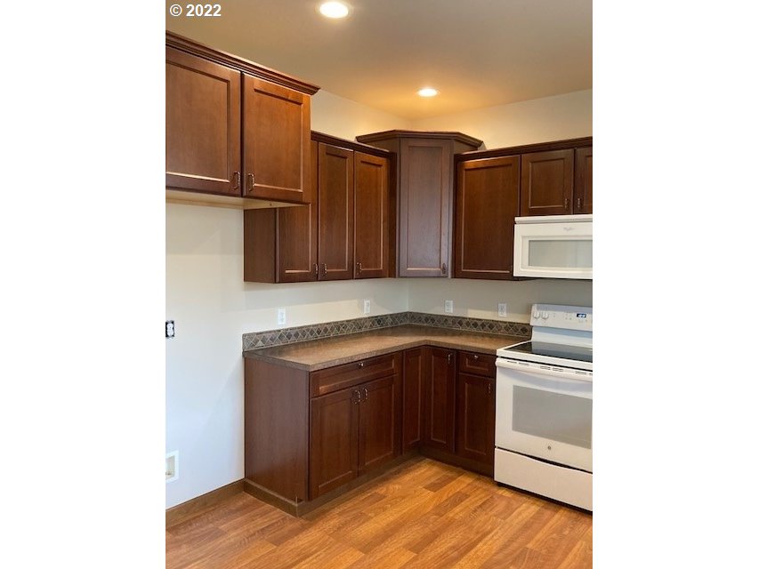 1734 Southwest 3rd Street Pendleton, OR 97801 - Photo 8 of 29 a kitchen with stainless steel appliances granite countertop a refrigerator and a stove top oven