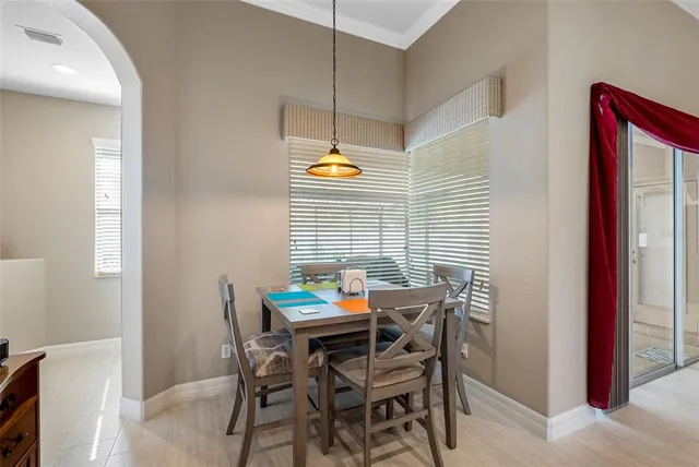 a view of a dining room with furniture and window