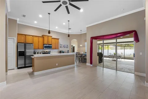 a large kitchen with a large counter top appliances and cabinets