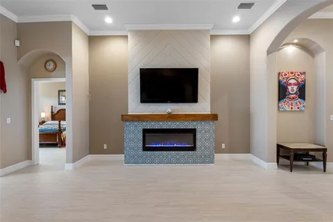 a living room with furniture a flat screen tv and a fireplace