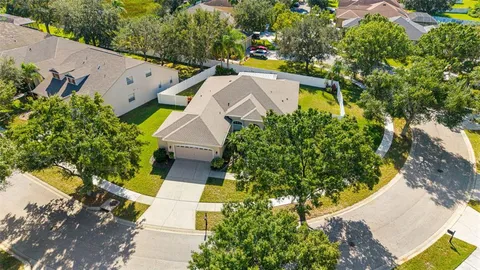 an aerial view of a house with a yard and garden
