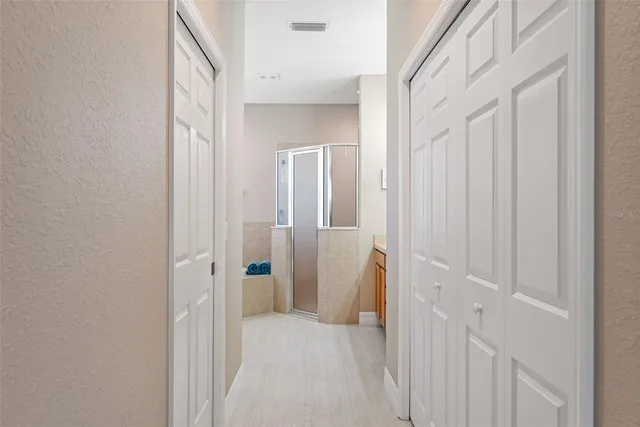 a bathroom with a tub sink and mirror