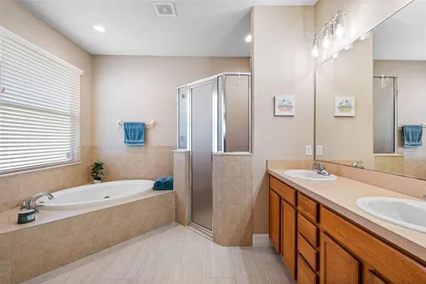 a bathroom with a double vanity sink and a mirror