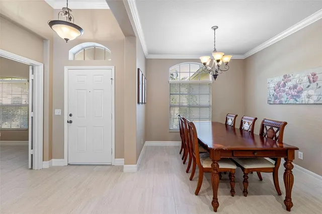 a view of a dining room with furniture a chandelier and wooden floor