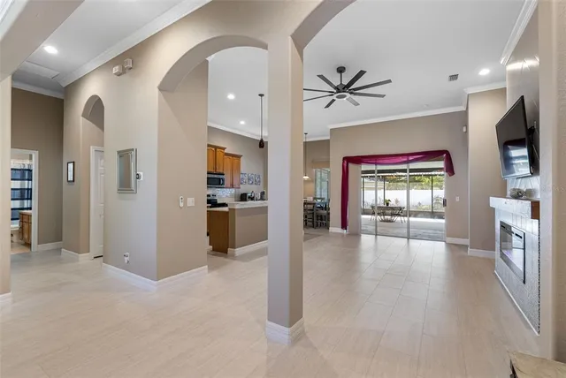 an open kitchen view with fireplace and windows