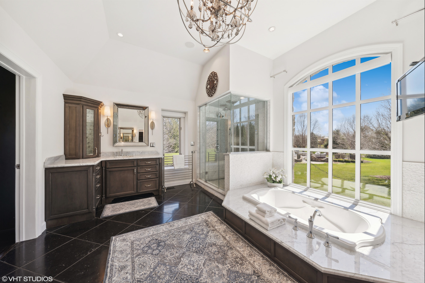 34-w033 White Thorne Road St. Charles, IL 60174 - Photo 39 of 100 a spacious bedroom with a large bed and a chandelier