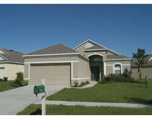 7708 Monarch Hill Way Apollo Beach, FL 33572 - Photo 1 of 1 a front view of a house with garden