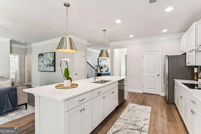 a view of a kitchen counter space a sink a window and stainless steel appliances