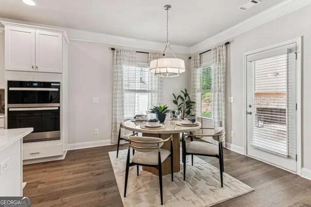 a view of a dining room with furniture window and wooden floor