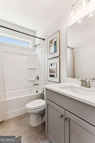a bathroom with a granite countertop sink toilet a shower and a mirror