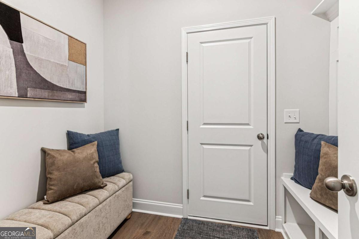 5537 Keswick Drive, Unit 8 Flowery Branch, GA 30542 - Photo 19 of 42 a living room with furniture and a gate