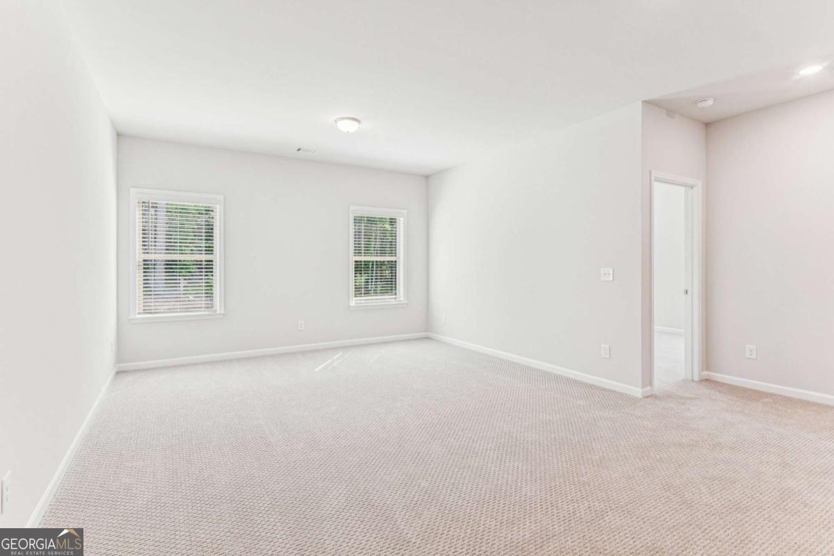 5537 Keswick Drive, Unit 8 Flowery Branch, GA 30542 - Photo 22 of 42 an empty room with windows
