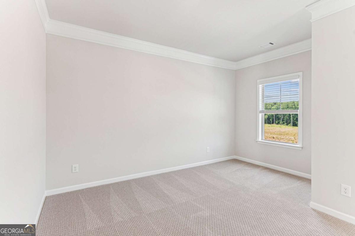 5537 Keswick Drive, Unit 8 Flowery Branch, GA 30542 - Photo 25 of 42 an empty room with a window