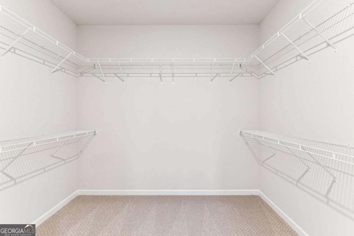 5537 Keswick Drive, Unit 8 Flowery Branch, GA 30542 - Photo 27 of 42 a view of a room with racks on the wall