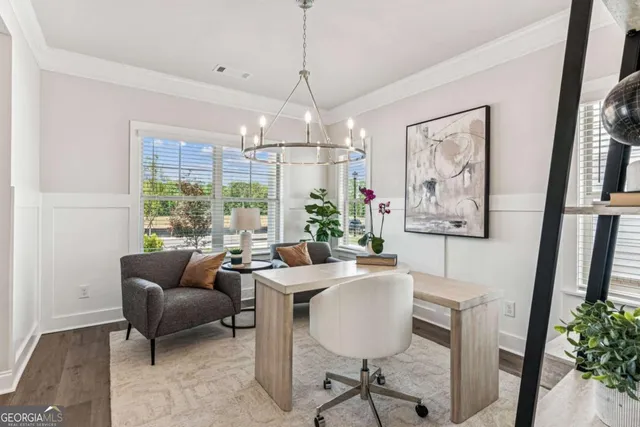 a dining room with furniture a chandelier and window