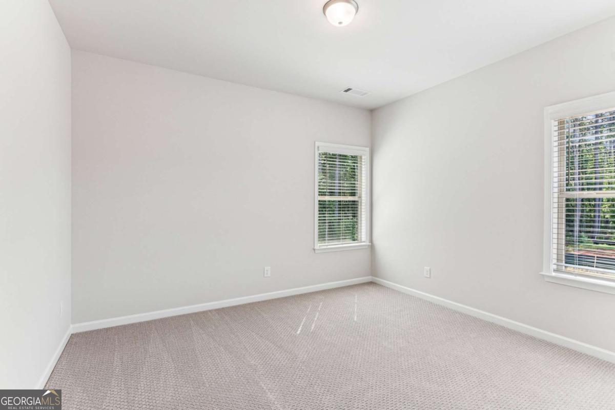 5537 Keswick Drive, Unit 8 Flowery Branch, GA 30542 - Photo 31 of 42 an empty room with a window