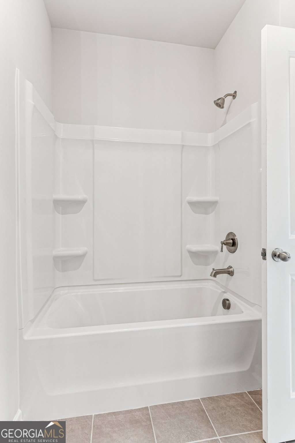 5537 Keswick Drive, Unit 8 Flowery Branch, GA 30542 - Photo 32 of 42 a bathroom with bathtub