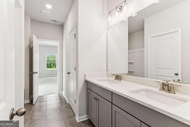 a bathroom with a double vanity sink and a mirror