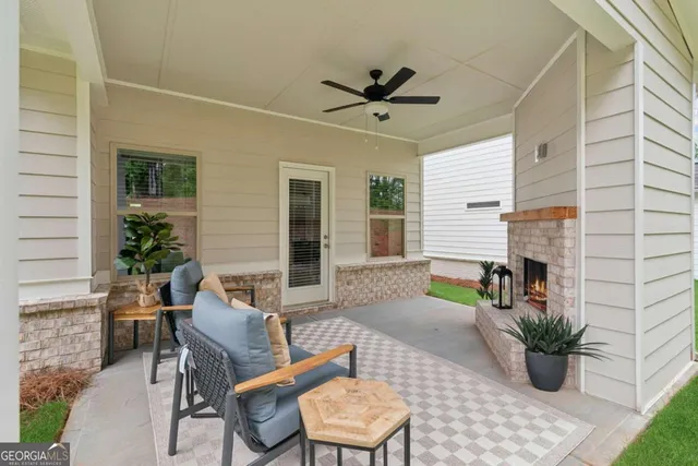 a view of a house with backyard and sitting area