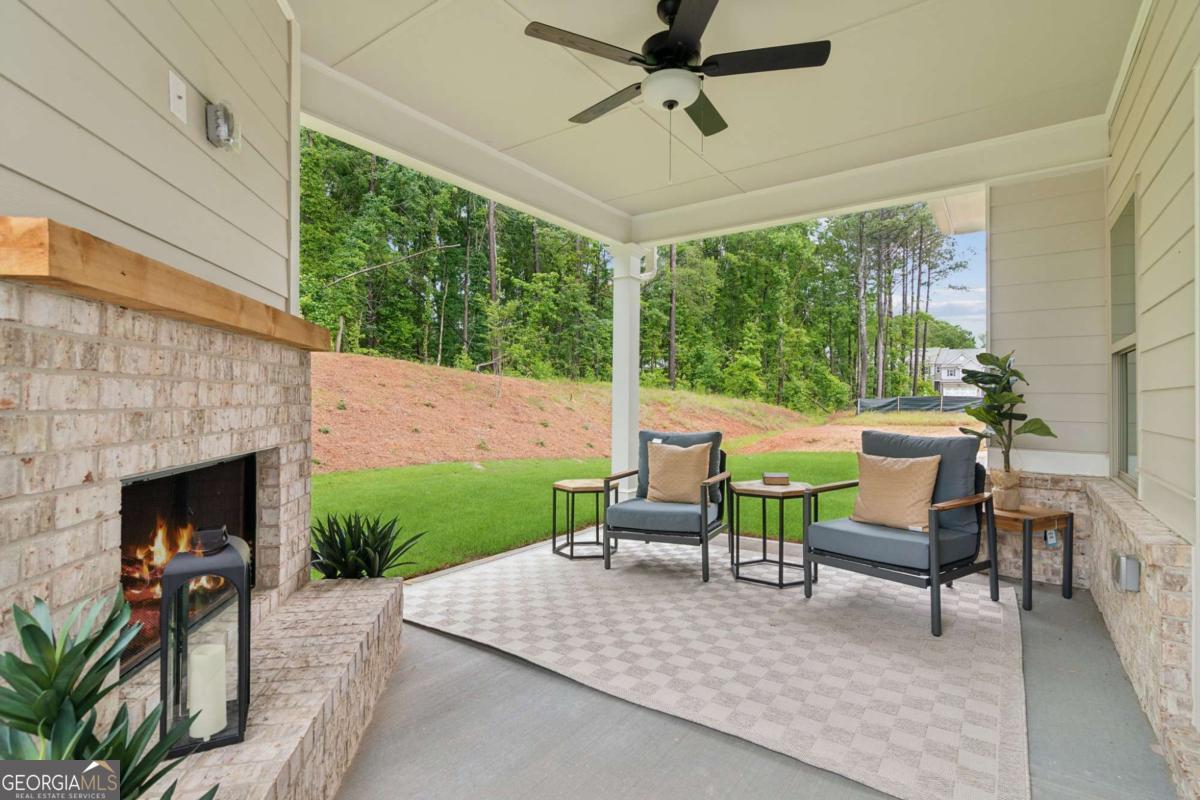 5537 Keswick Drive, Unit 8 Flowery Branch, GA 30542 - Photo 40 of 42 a living room with furniture and a fireplace