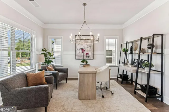 a living room with furniture a chandelier and a chandelier