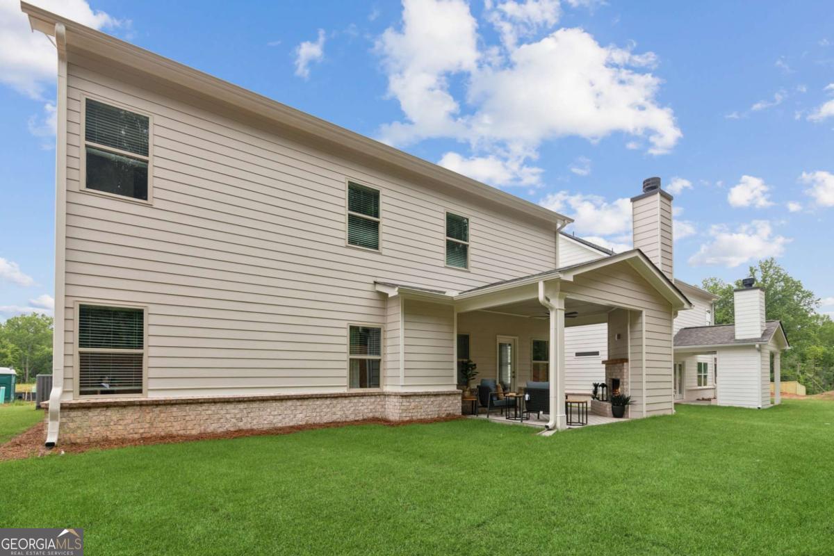 5537 Keswick Drive, Unit 8 Flowery Branch, GA 30542 - Photo 41 of 42 a view of a house with a backyard