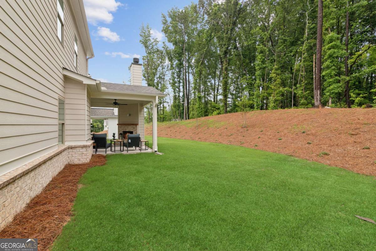 5537 Keswick Drive, Unit 8 Flowery Branch, GA 30542 - Photo 42 of 42 a view of a backyard with sitting area
