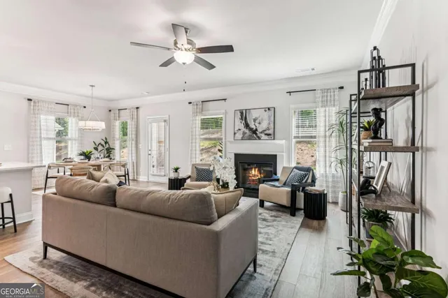 a living room with furniture a fireplace and a window