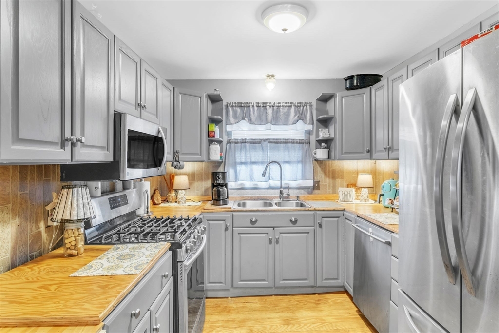 89 Pine Grove Street Springfield, MA 01119 - Photo 11 of 26 a kitchen with stainless steel appliances granite countertop a refrigerator sink and stove