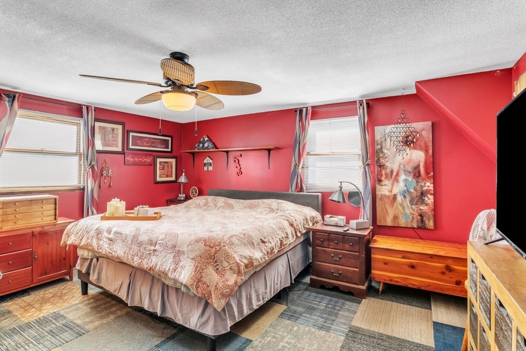 89 Pine Grove Street Springfield, MA 01119 - Photo 20 of 26 a bedroom with a bed and a chandelier