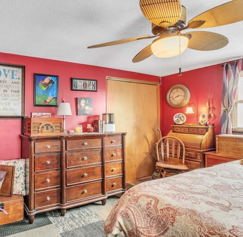 89 Pine Grove Street Springfield, MA 01119 - Photo 22 of 26 a bedroom with a bed and a chandelier