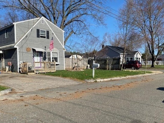 89 Pine Grove Street Springfield, MA 01119 - Photo 24 of 26 a front view of a house with a yard and garage