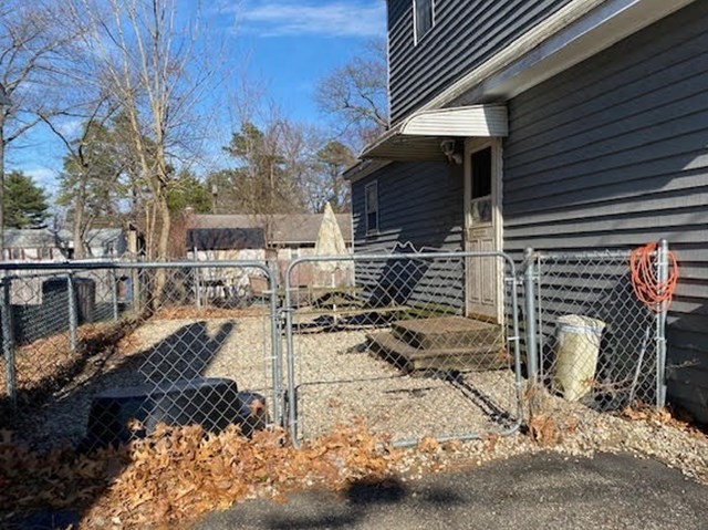 89 Pine Grove Street Springfield, MA 01119 - Photo 25 of 26 a view of a patio with chair and tables back yard of the house