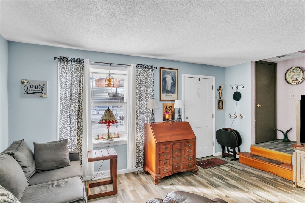 89 Pine Grove Street Springfield, MA 01119 - Photo 4 of 26 a living room with furniture a table and a large window