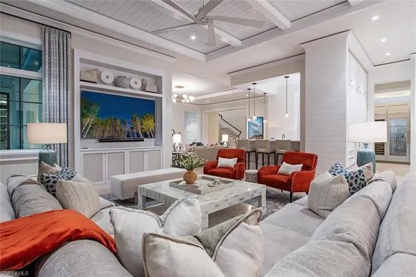 a living room with furniture ceiling fan and a rug