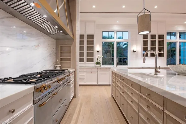 a kitchen with stainless steel appliances granite countertop a stove and a sink