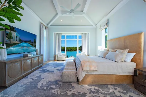 a bed room with a bed and a large window